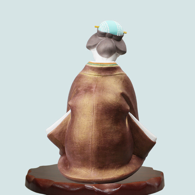 Hakata Doll Good Fortune showing traditional craftsman Ueki Susumu's Ofuku-san in detailed brown kimono.