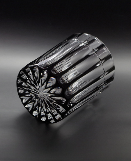 Cross Rock glass made of black crystal with elegant cross cuts and a reflective patterned bottom design.