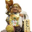 Daikokuten Hakata Doll by Susumu Ueki, 25cm tall, featuring gold and white traditional attire on wooden base.