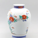 Flower vase, dyed brocade, chrysanthemum and bird design with intricate floral patterns on white porcelain surface.