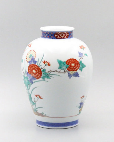 Flower vase, dyed brocade, chrysanthemum and bird design with intricate floral patterns on white porcelain surface.