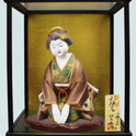 Hakata Doll Good Fortune featuring traditional Ofuku-san figure in glass case with nameplate and intricate kimono details.