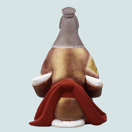 Hakata Doll Tea ceremony showing back view of a 23cm figure in traditional gold and red attire by Susumu Ueki