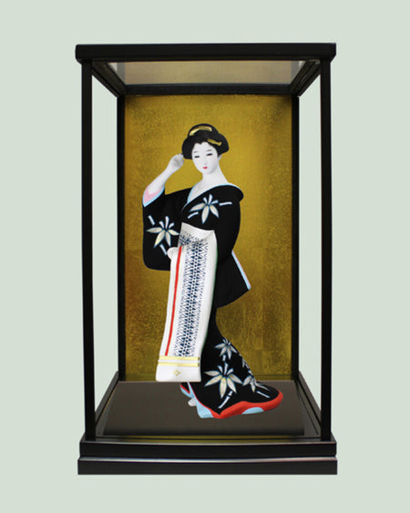 Hakata Presentation showing Hakata Doll Hakata Kenjo by Kenju in glass case with black and gold background