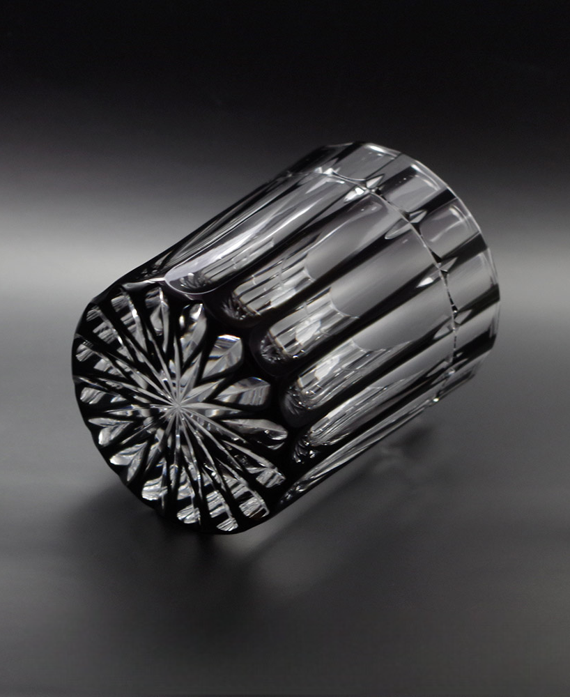 Cross Rock glass made of black crystal with elegant cross cuts and a reflective patterned bottom design.